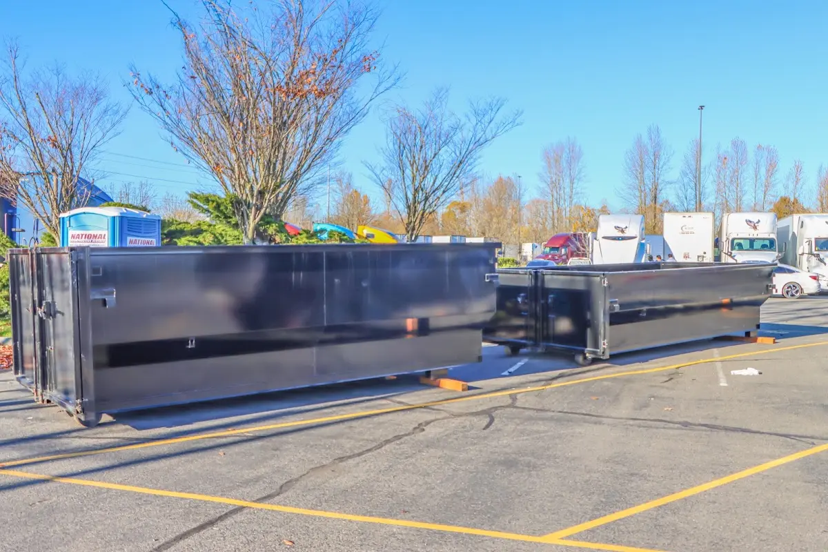 Professional dumpster rental service with roll-off container on residential driveway in Mililani Mauka